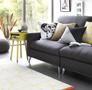 Grey sofa with yellow Habitat side table and yellow cushions.