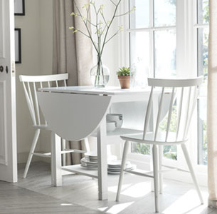White drop leaf table folded down for extra space.