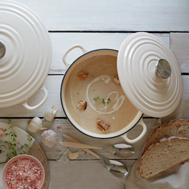 A warming parsnip soup sits in a large cream casserole dish.