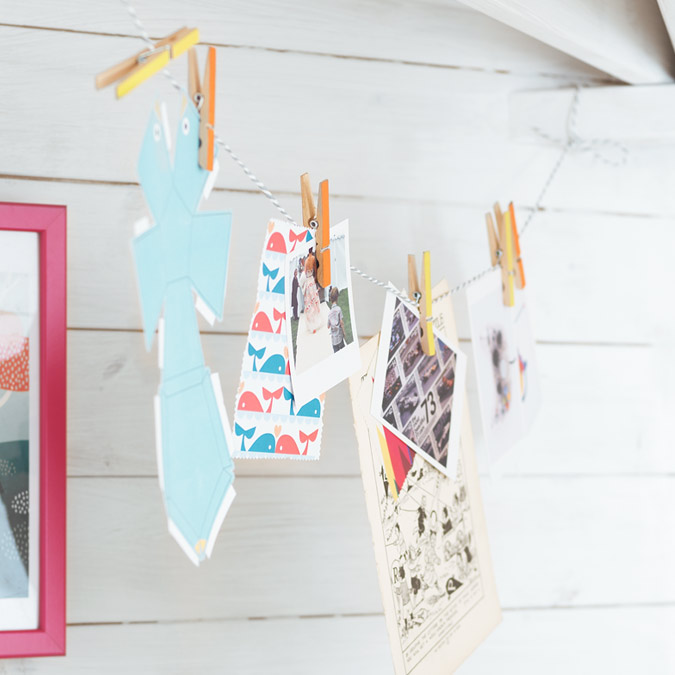 Image of kids' artwork pegged to a string.