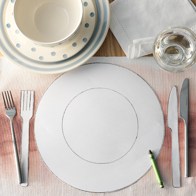 Image of a paper cut out dining set with colouring crayons.