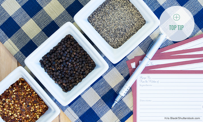 Table containing assorted dishes and several blank recipe cards