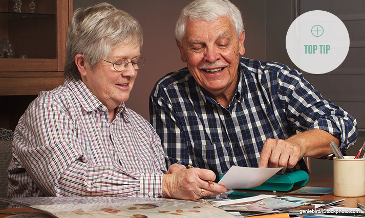 Man and woman creating a scrapbook together