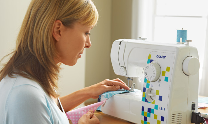 Woman using a Brother sewing machine.