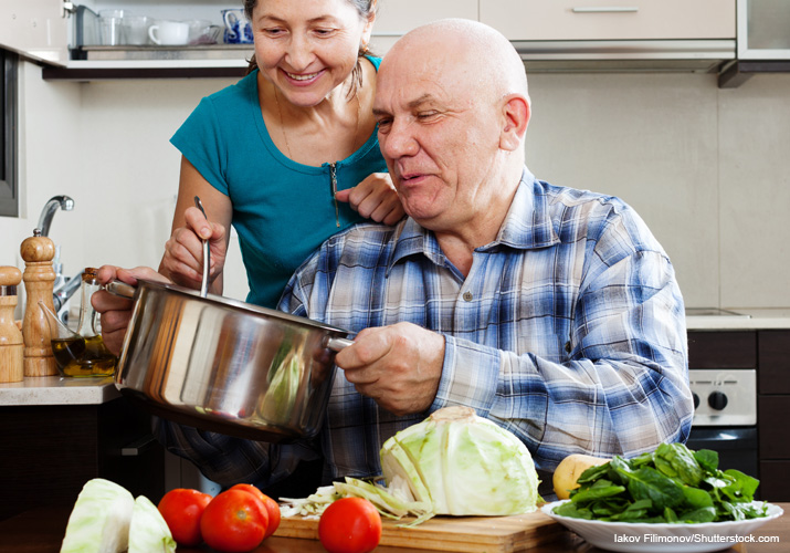 Man and woman cooking healthy meal.