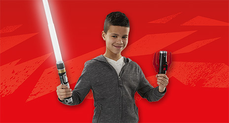 Image of a boy holding a lightsaber in each hand, one is activated.