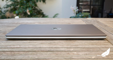 Image of a HP laptop closed on a wooden bench.