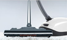 Image of the floorhead on the end of a white Meili vacuum cleaner.