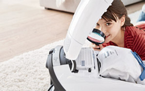Lifestyle image showing the Miele multi stage filteration system on a white Miele vacuum cleaner.