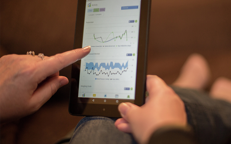 Image of someone reviewing sleep stats on a tablet.