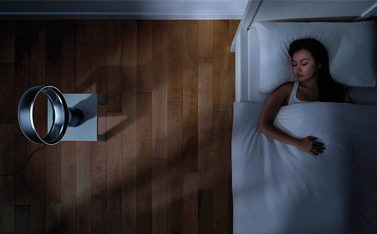 Image of a woman sleeping with a Dyson fan.