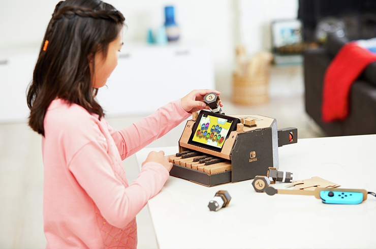 Nintendo Switch consoles combined with fun cardboard designs to make interactive toys, such as a keyboard and driving game.