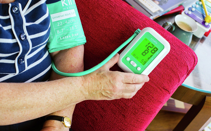 Older woman checking blood pressure