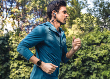 Running man wearing fitness tracker