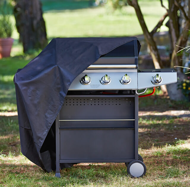An image of a barbeque half covered by a plastic barbeque cover.