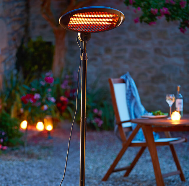 Garden Party Accessories Ideas Argos A Tall Patio Heater Standing Next To An Outdoor Wooden Table And Chair Set