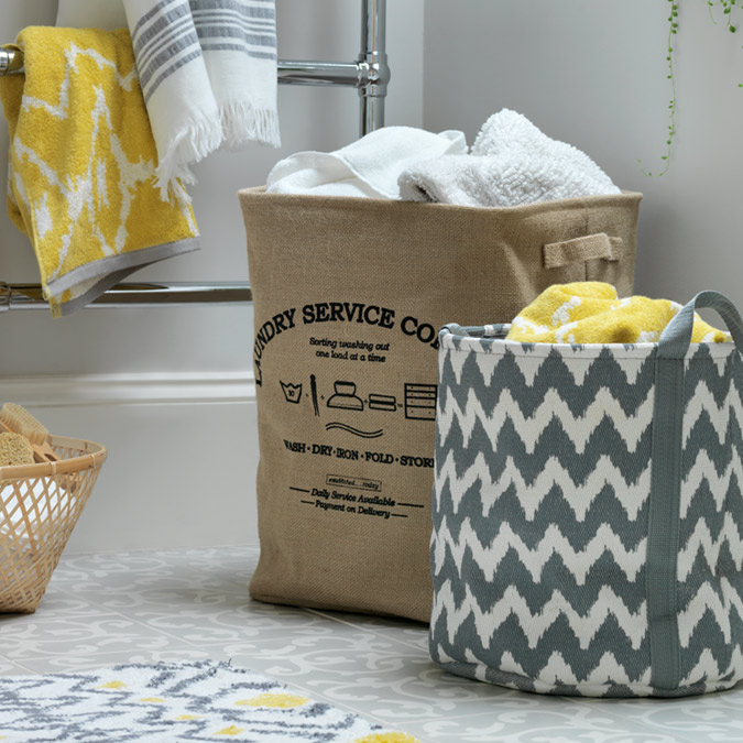 Hessian and chevron style laundry baskets in small bathroom.