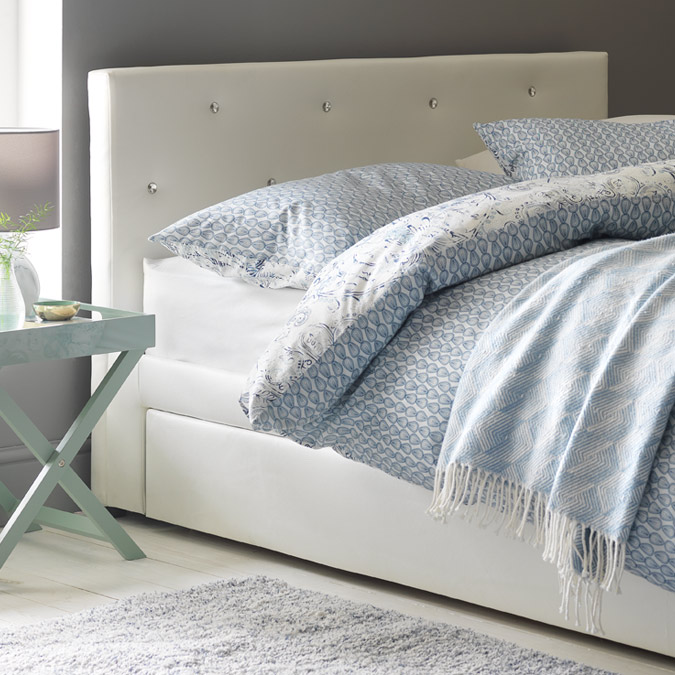 Bed Ideas Argos A Cream Fabric Upholstered Strorage Bed With Patterned Bedding