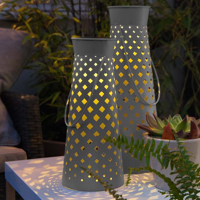 Two metal lanterns with cut-work design.
