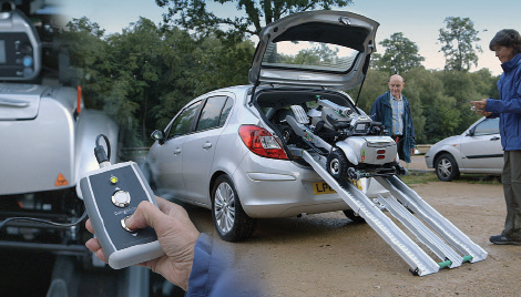 Folded Quingo scooter being driven from boot of car via remote.