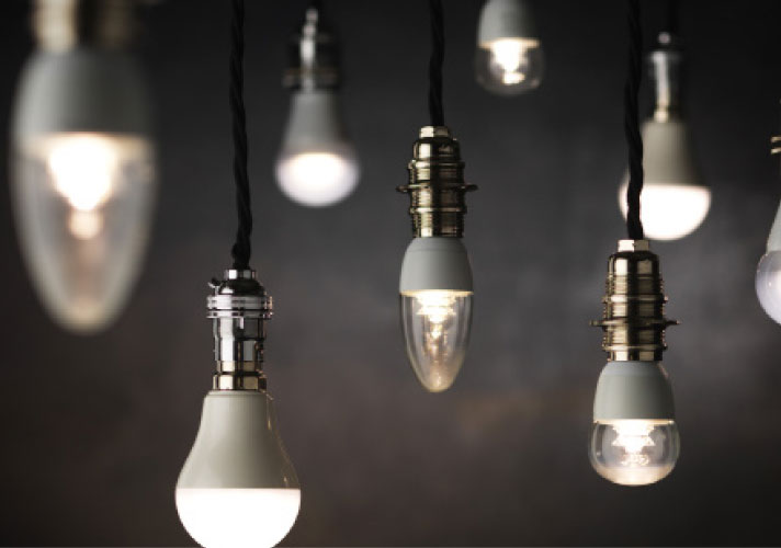 Assorted light bulbs hanging from the ceiling.