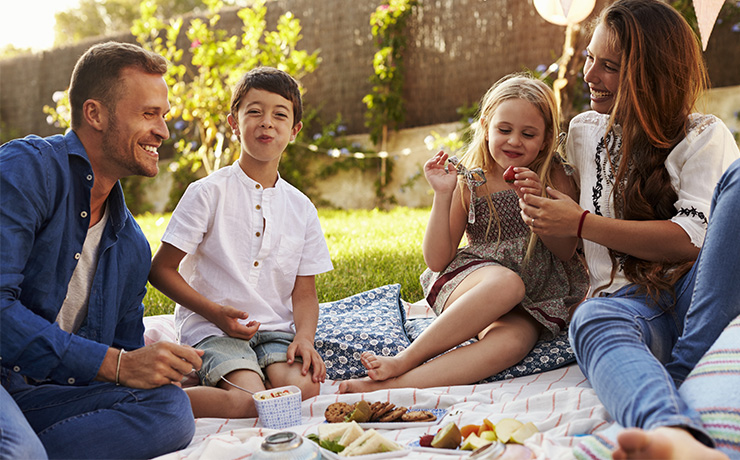 Image of a family having a picnic in their garden