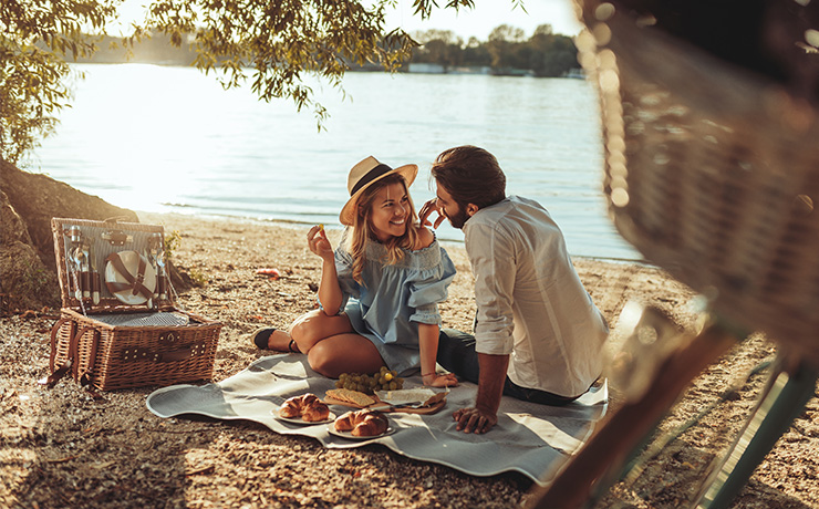 Image of a couple having a picnic on the beach