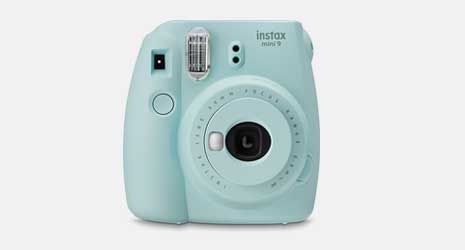 Cut-out image of an ice blue instax Mini 9 instant camera on a grey background.