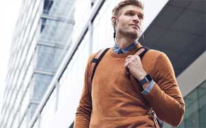 Image of a man outside a building wearing a Fitbit Ionic.