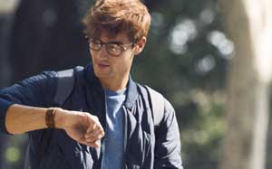 Image of a man outside checking his Fitbit Versa.