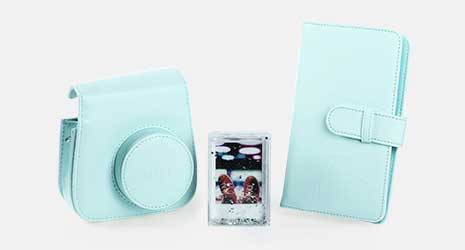 Cut-out images of an instax Mini 9 camera case, a photo album and a glitter water frame from the instax Mini 9 accessory kit in ice blue.
