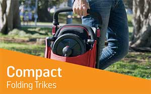 Image of a person carrying a folded up SmarTrike trike.
