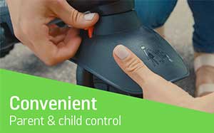 Image of a hand pressing the switch control button on the front of a SmarTrike trike.