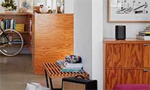 Image of a room with a Sonos speaker placed on a sideboard.