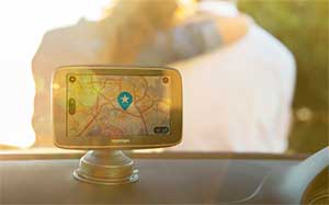 Image of a TomTom sat nav mounted on a cars dashboard.