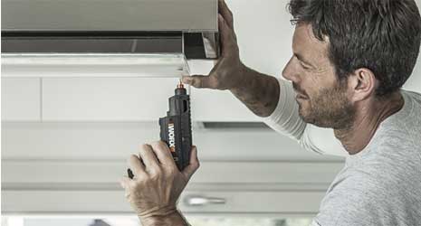Image of a man using a WORX screwdriver.
